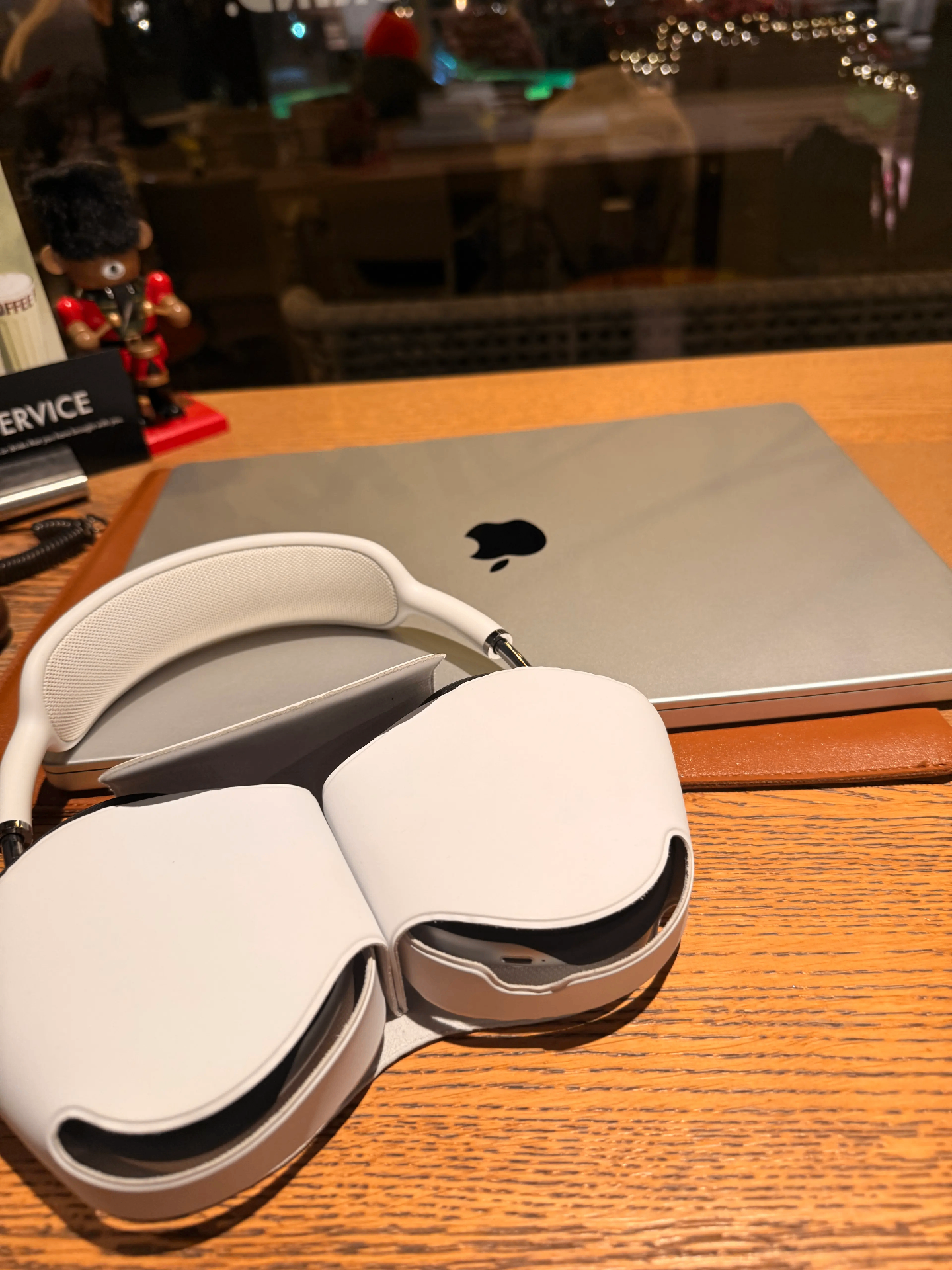 Starlight Hidden Maxes headphones in case next to a MacBook